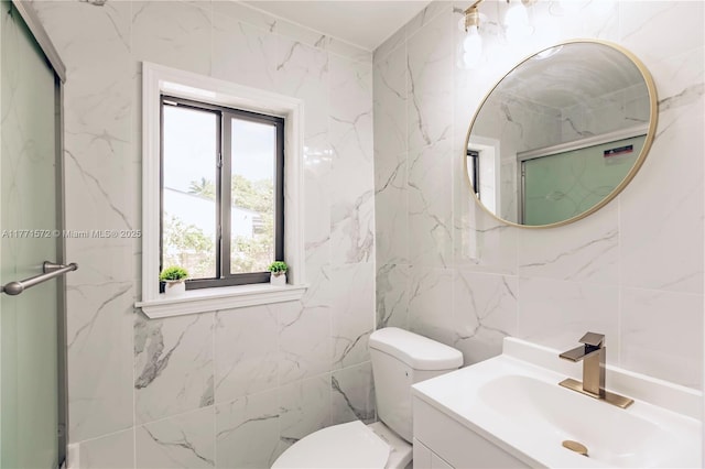 full bath with toilet, vanity, tile walls, and a stall shower