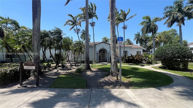 mediterranean / spanish-style house with a front lawn and stucco siding
