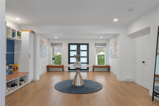 interior space with recessed lighting, french doors, and light wood-type flooring