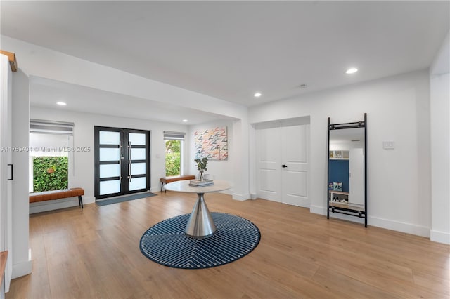 entrance foyer featuring recessed lighting, french doors, light wood-type flooring, and a barn door