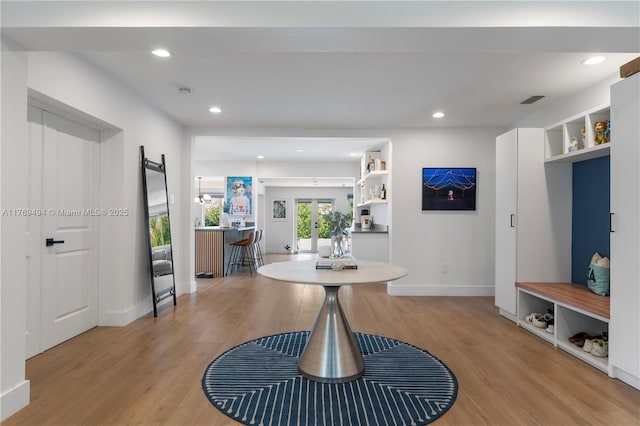 interior space featuring recessed lighting, baseboards, light wood finished floors, and visible vents
