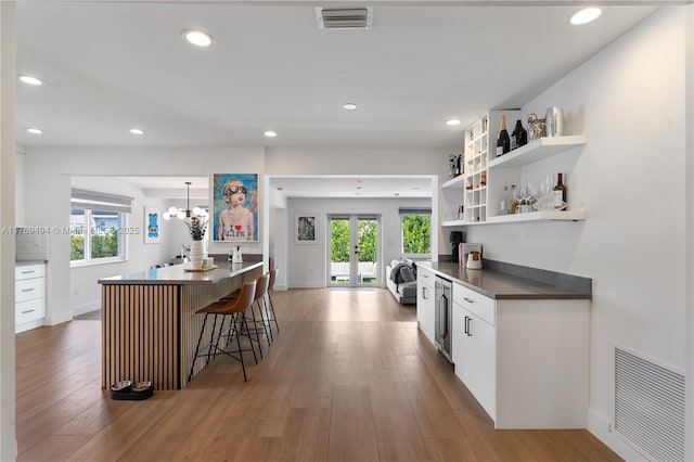 bar featuring plenty of natural light, french doors, and visible vents