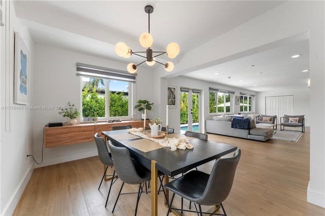 dining room featuring recessed lighting, baseboards, a notable chandelier, and light wood-style floors