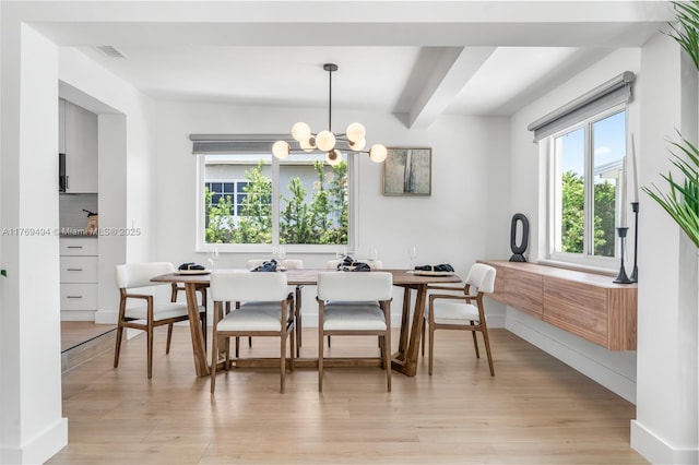 3291 SW 16th Ln, Miami, FL 33145 - dining room featuring light wood-style floors, a chandelier, beamed ceiling, and baseboards