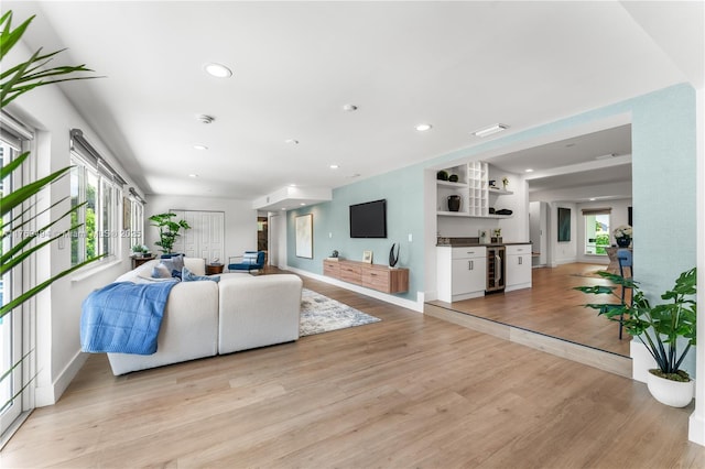 3291 SW 16th Ln, Miami, FL 33145 - living room with beverage cooler, light wood finished floors, a bar, baseboards, and recessed lighting