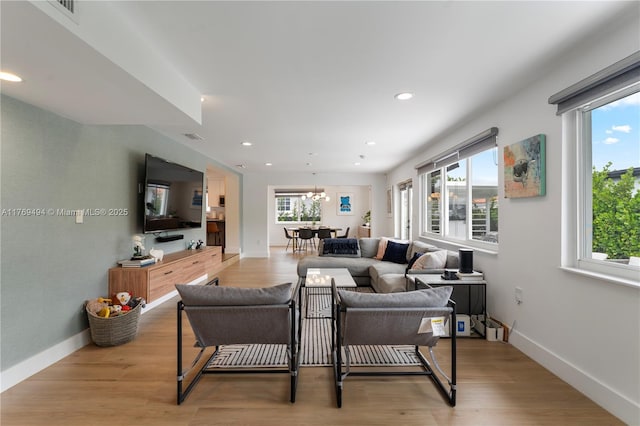 living room featuring recessed lighting and a healthy amount of sunlight