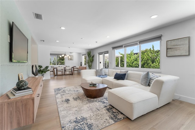 3291 SW 16th Ln, Miami, FL 33145 - living area with plenty of natural light, a chandelier, recessed lighting, light wood-style floors, and baseboards
