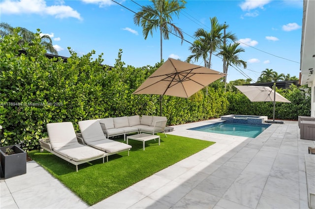 view of pool with a lawn, a patio, an in ground hot tub, and an outdoor living space