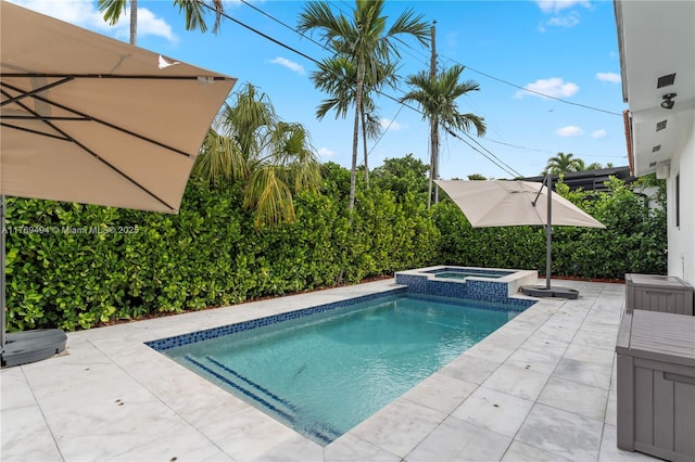 view of swimming pool with a patio and a pool with connected hot tub