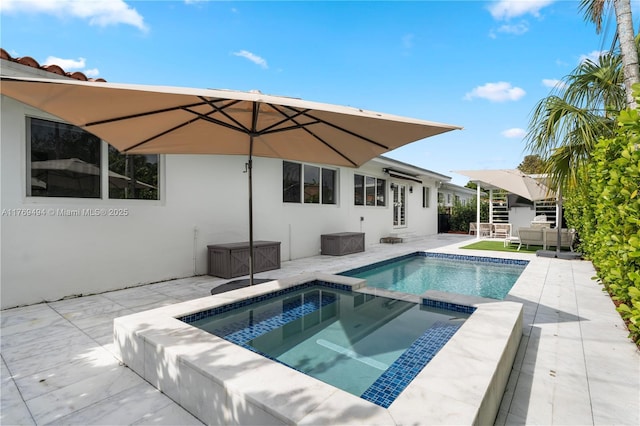 view of pool featuring an outdoor hangout area, a patio, and an in ground hot tub