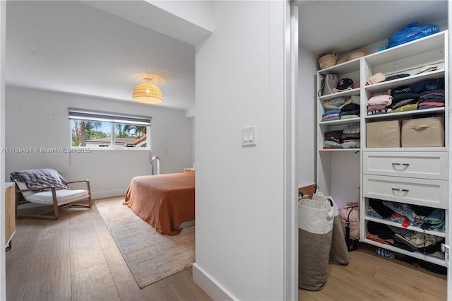 bedroom with baseboards and light wood-style floors