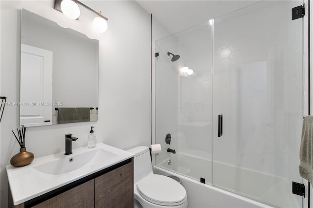 bathroom with vanity, bath / shower combo with glass door, and toilet