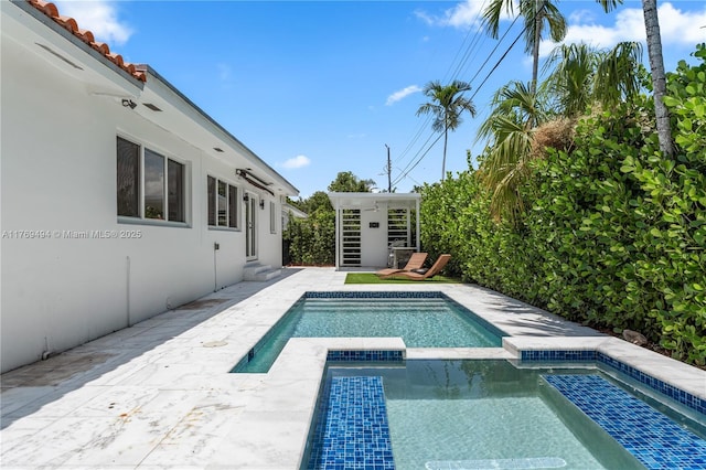 3291 SW 16th Ln, Miami, FL 33145 - view of swimming pool with entry steps, a pool with connected hot tub, and a patio area
