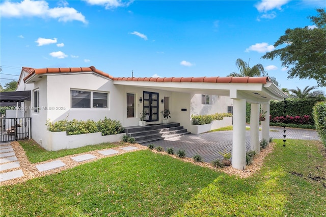 3291 SW 16th Ln, Miami, FL 33145 - mediterranean / spanish-style home with a front yard, a tile roof, and stucco siding
