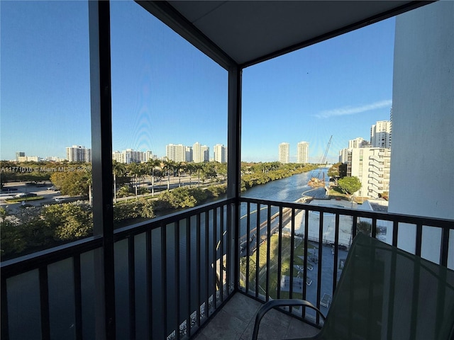 balcony featuring a view of city and a water view