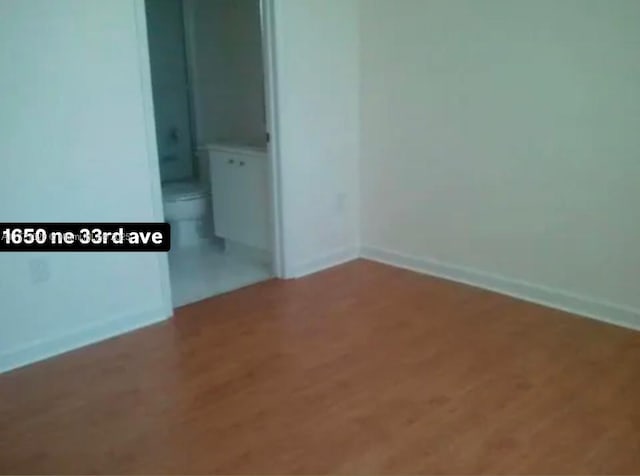 1650 NE 33rd Ave Unit 105-7, Homestead, FL 33033 - spare room featuring baseboards and wood finished floors