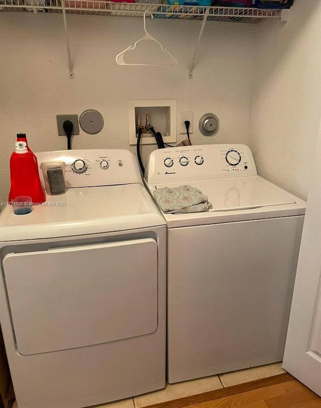 1650 NE 33rd Ave Unit 105-7, Homestead, FL 33033 - laundry area featuring separate washer and dryer, light wood-style flooring, and laundry area