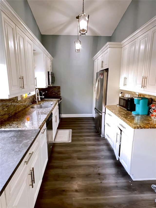 kitchen with decorative backsplash, white cabinets, baseboards, appliances with stainless steel finishes, and dark wood-type flooring