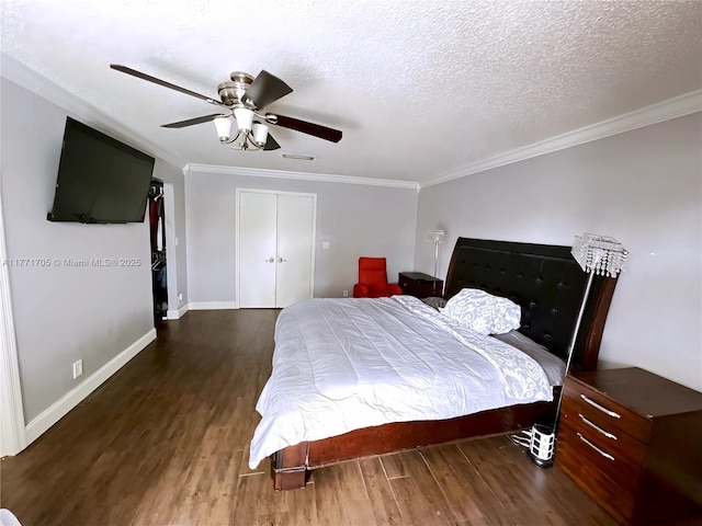 bedroom featuring baseboards, wood finished floors, and ornamental molding