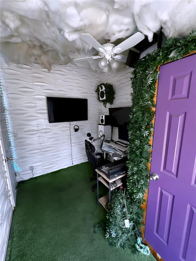 carpeted home office featuring a ceiling fan