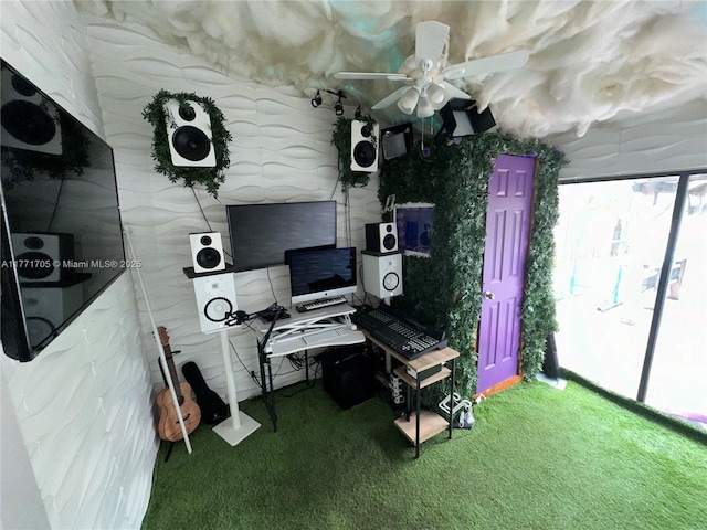 interior space with a ceiling fan and carpet flooring