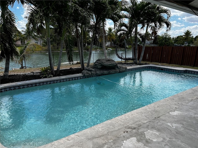 view of swimming pool featuring a fenced backyard, a fenced in pool, and a water view