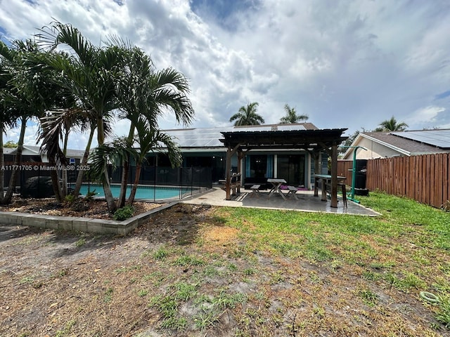 rear view of house with a pergola, a fenced backyard, a patio, a fenced in pool, and metal roof