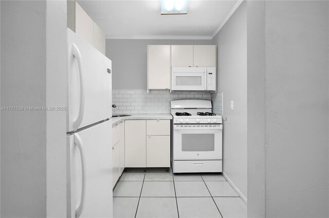 kitchen with light countertops, backsplash, ornamental molding, light tile patterned floors, and white appliances