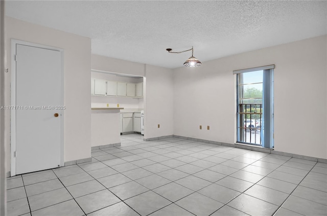 6886 N Kendall Dr Unit D208, Pinecrest, FL 33156 - unfurnished living room with a textured ceiling and light tile patterned flooring