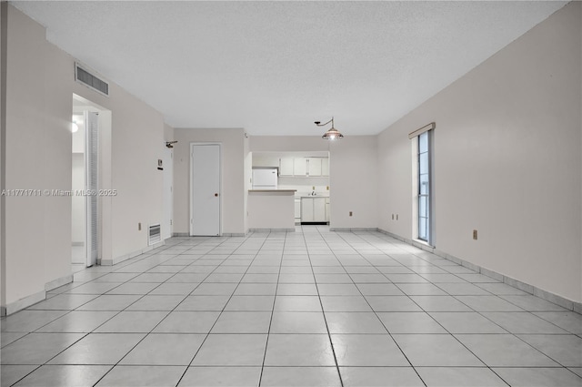 6886 N Kendall Dr Unit D208, Pinecrest, FL 33156 - unfurnished living room featuring light tile patterned floors and a textured ceiling