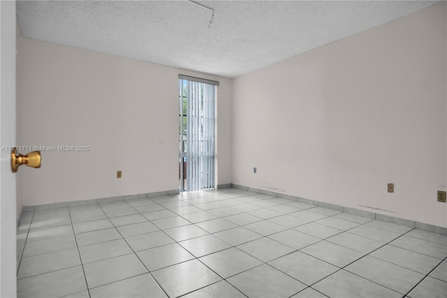 6886 N Kendall Dr Unit D208, Pinecrest, FL 33156 - empty room featuring a textured ceiling and light tile patterned floors
