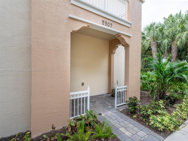 property entrance with stucco siding