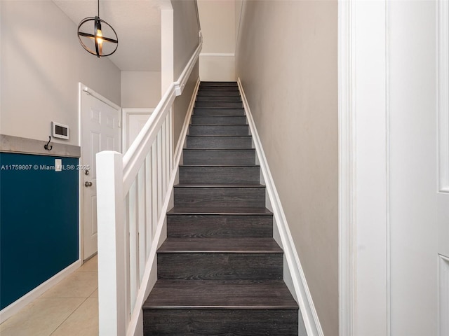 stairway featuring tile patterned flooring