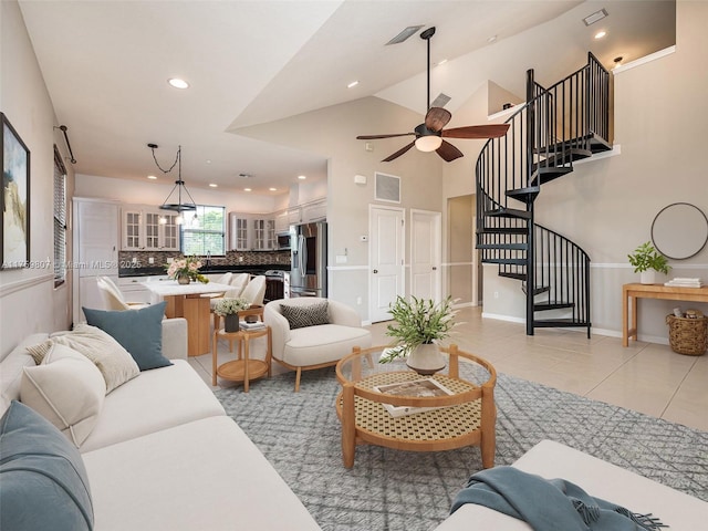 living area with visible vents, light tile patterned floors, a ceiling fan, stairway, and recessed lighting