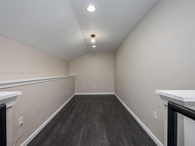 bonus room with baseboards, recessed lighting, a textured ceiling, lofted ceiling, and wood finished floors