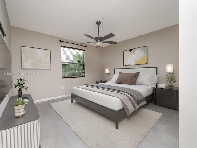 bedroom with light tile patterned floors, baseboards, and ceiling fan