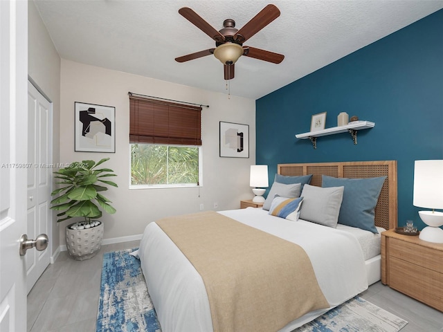 bedroom featuring ceiling fan and baseboards