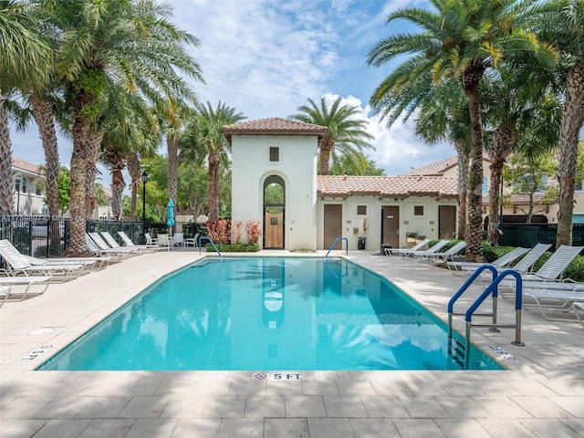 pool featuring a patio area and fence