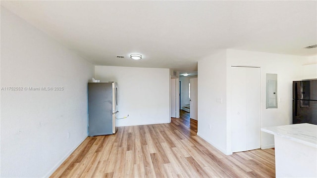 219 SW 6th Ln, Florida City, FL 33034 - spare room with visible vents, a baseboard radiator, light wood-style floors, and electric panel