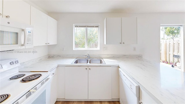 219 SW 6th Ln, Florida City, FL 33034 - kitchen featuring white cabinetry, white appliances, light stone countertops, and a sink