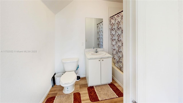 219 SW 6th Ln, Florida City, FL 33034 - full bath featuring wood finished floors, toilet, vanity, baseboards, and shower / tub combo