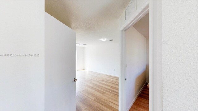 219 SW 6th Ln, Florida City, FL 33034 - hall with visible vents, light wood-type flooring, and baseboards