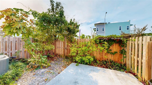 219 SW 6th Ln, Florida City, FL 33034 - view of yard with a fenced backyard, central air condition unit, and a patio area