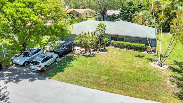 766 NW 24th Ave, Delray Beach, FL 33445 - view of front facade featuring a front yard and roof with shingles