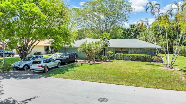 766 NW 24th Ave, Delray Beach, FL 33445 - view of front of house featuring a front lawn, driveway, and a garage