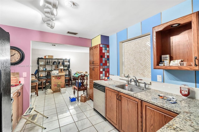766 NW 24th Ave, Delray Beach, FL 33445 - kitchen featuring stainless steel dishwasher, a sink, light tile patterned flooring, brown cabinets, and light stone countertops