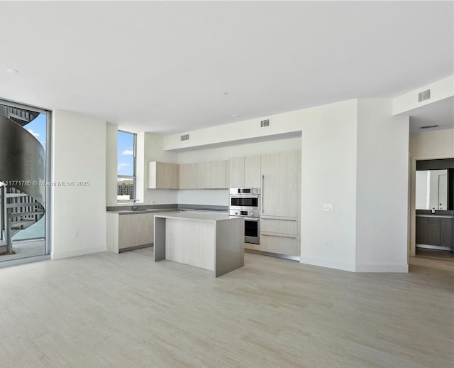 4010 S Ocean Dr Unit T4301, Hollywood, FL 33019 - kitchen featuring a center island, light brown cabinetry, visible vents, light wood-style flooring, and modern cabinets