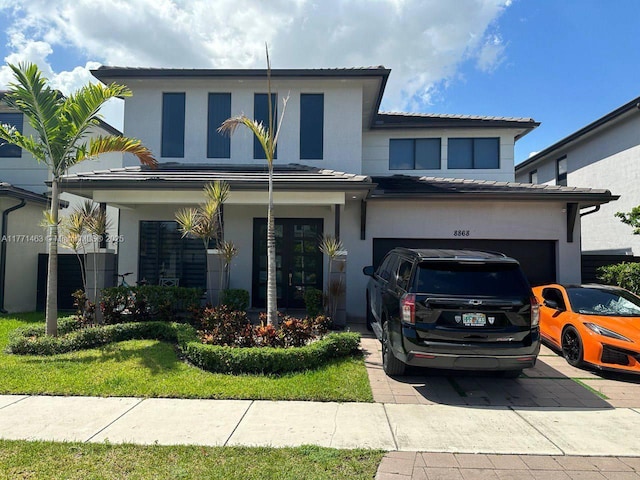 8868 NW 161st Ter, Miami Lakes, FL 33018 - view of front of property with driveway, a garage, stucco siding, and a tiled roof