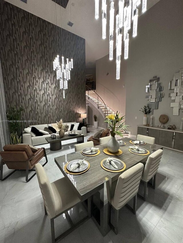 8868 NW 161st Ter, Miami Lakes, FL 33018 - dining area featuring stairway, an accent wall, a high ceiling, and marble finish floors