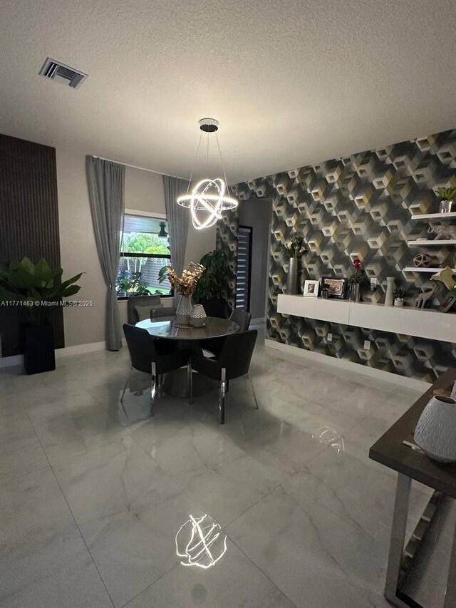 8868 NW 161st Ter, Miami Lakes, FL 33018 - dining area with a chandelier, marble finish flooring, and a textured ceiling